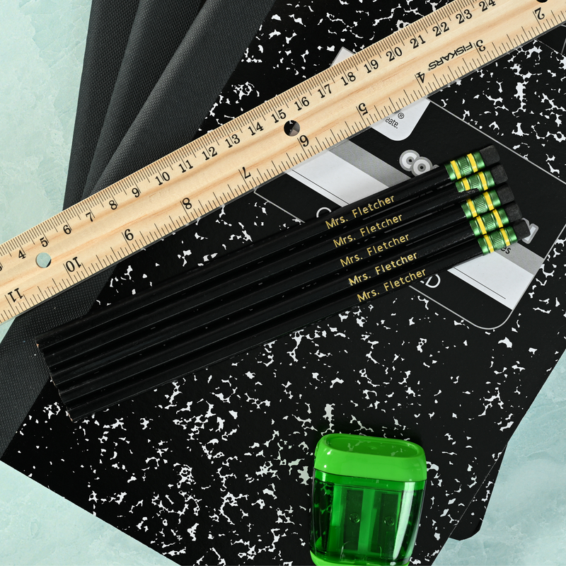 Black personalized pencils showing custom name stamping in metallic foil