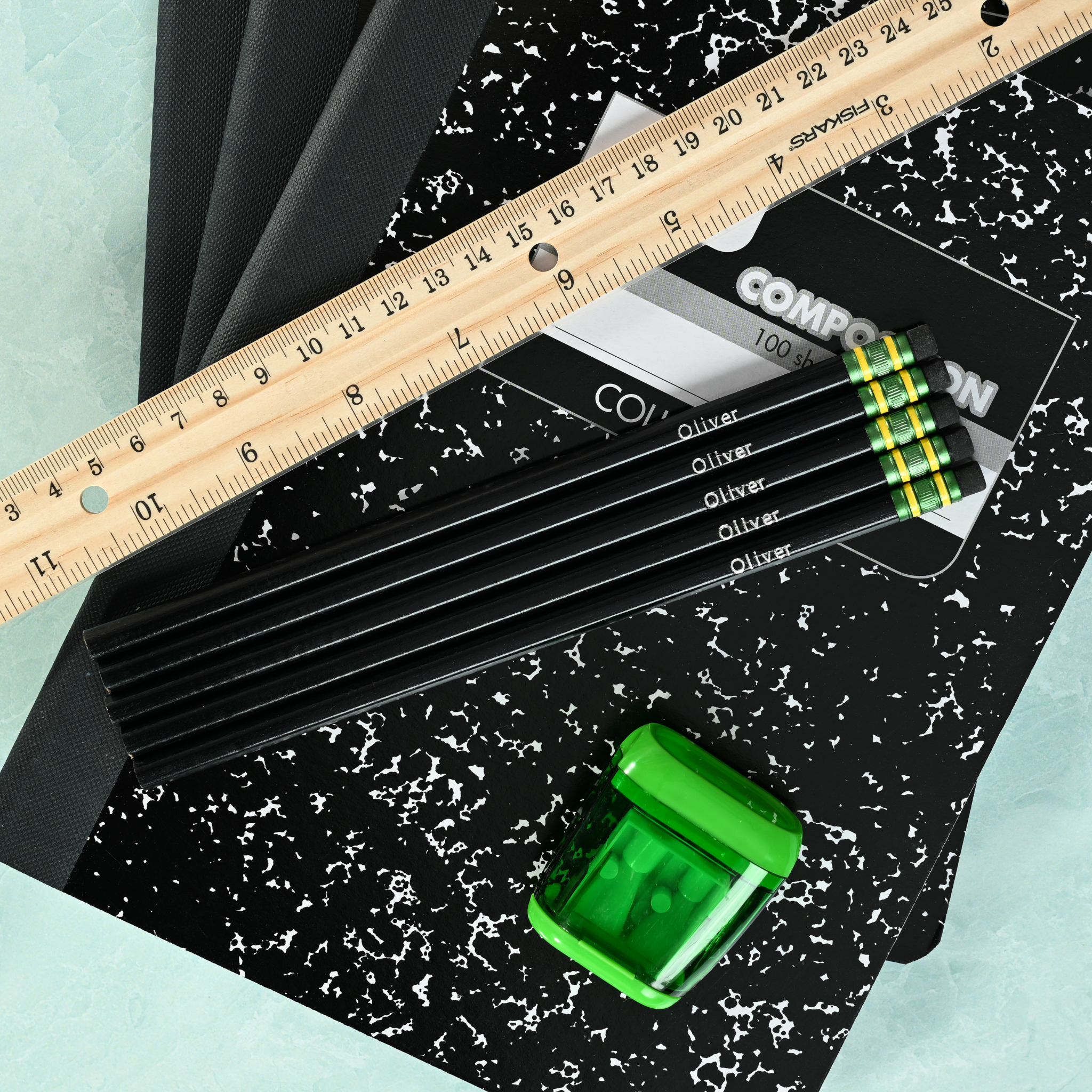 Black personalized pencils showing custom name stamping in metallic foil