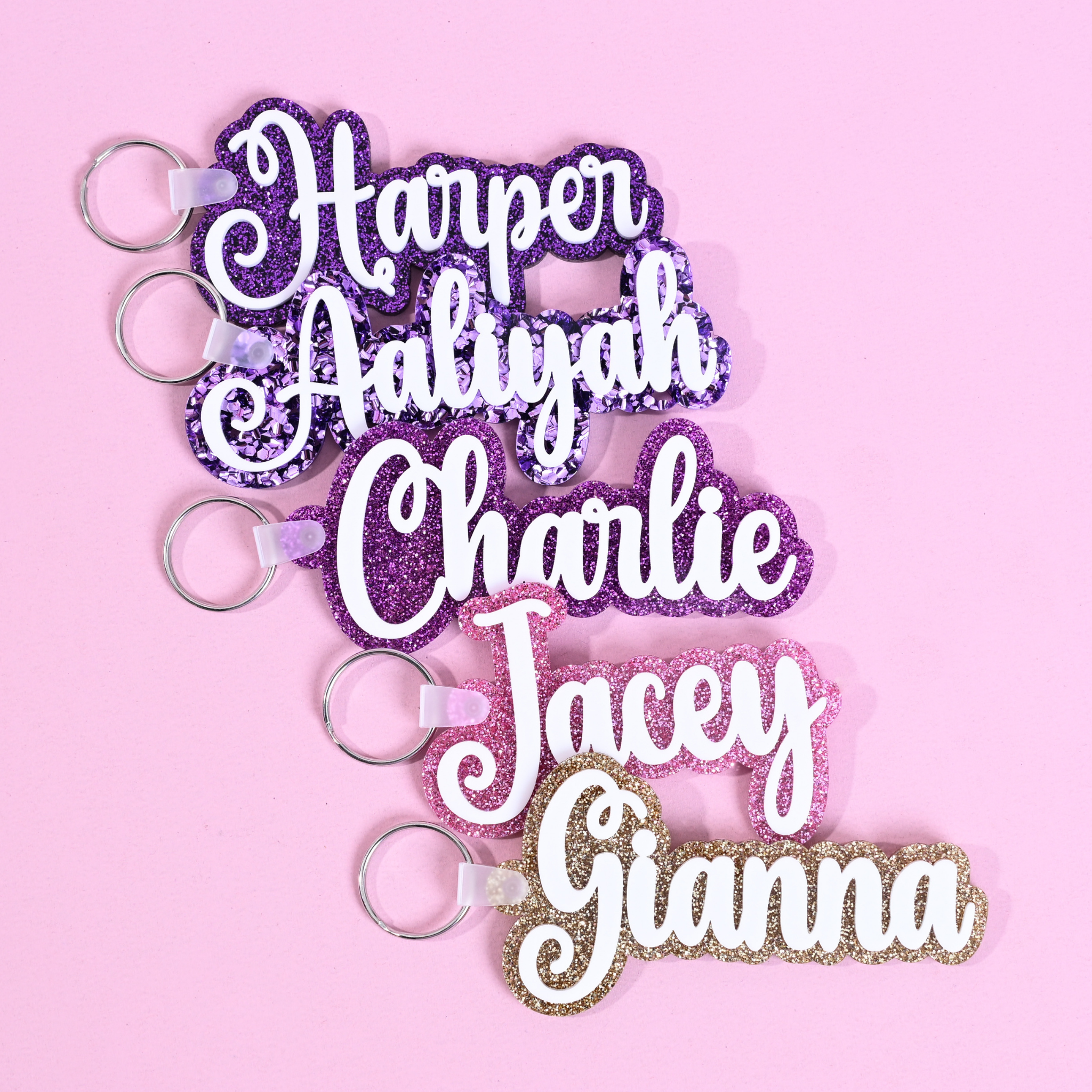 Personalized bag tags showing custom name engraving on durable acrylic with key ring attachment