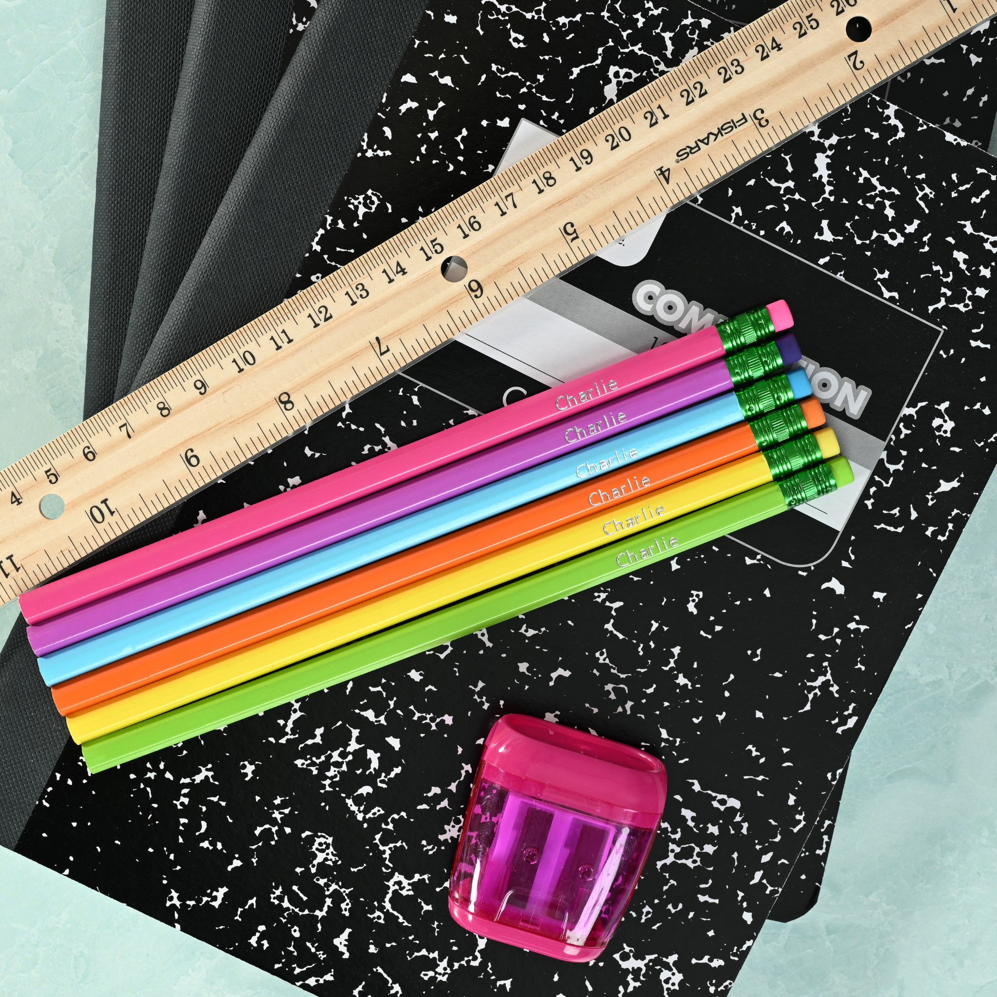 Bright personalized pencils showing custom name stamping in metallic foil