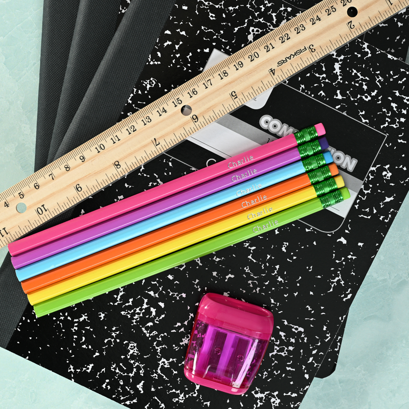 Bright personalized pencils showing custom name stamping in metallic foil