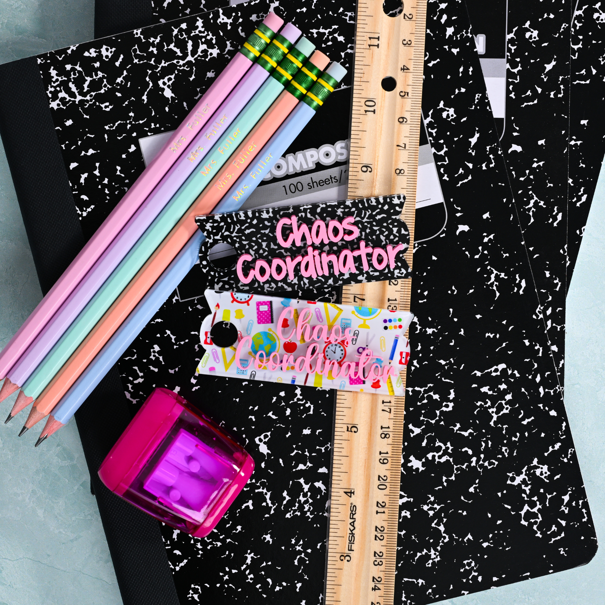 Topper Tag composition book and school supplies for Stanley Quencher showing custom name tag attachment that reads "Chaos Coordinator"