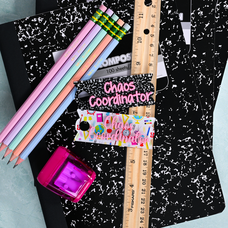 Topper Tag composition book and school supplies for Stanley Quencher showing custom name tag attachment that reads "Chaos Coordinator"