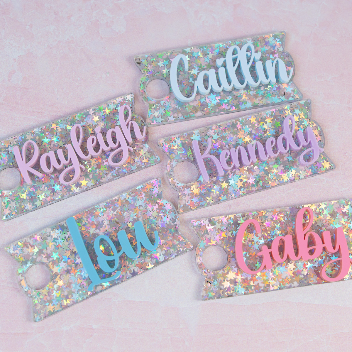Sparkly glitter star Topper Tag showing personalized names on Stanley Quencher tumblers with shimmering acrylic construction
