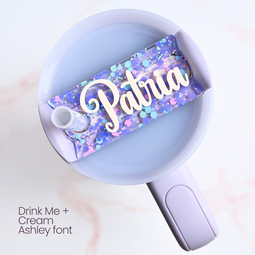 Mug with a colorful straw holder labeled 'Patria' on a light background