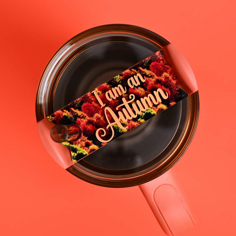 Stanley tumbler in orange with a Topper Tag name plate on top reads "I am an autumn". Fall themed tumbler accesory