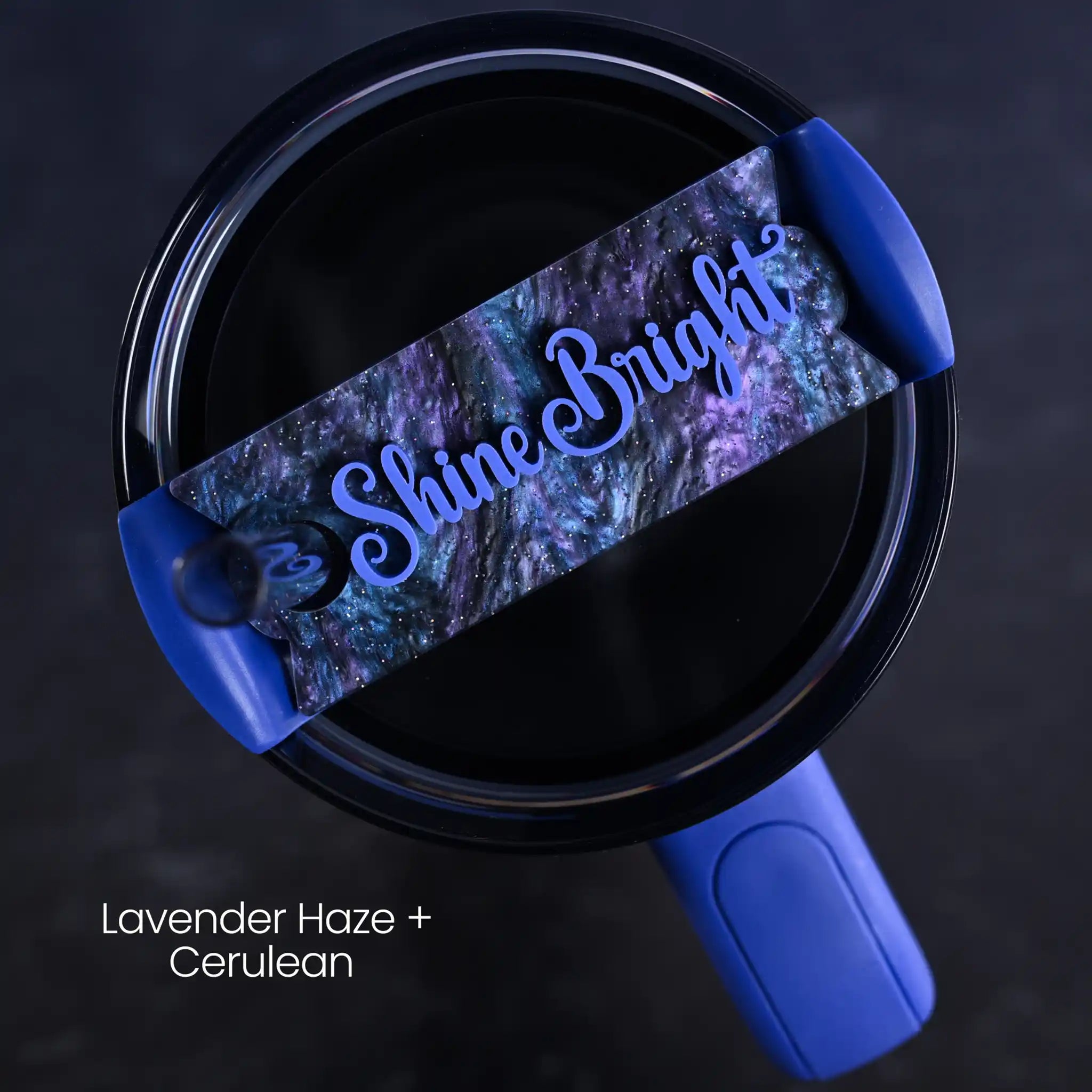Blue tumbler accessory shown on top of a Stanley Quencher H2.0 tumbler personalized with 'Shine Bright' saying written in a Cerulean color  on top of a purple and dark blue swirly acrylic  background