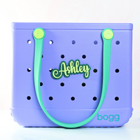 Personalized boggy button Custom Tote Bag Charm attached to a bogg bag with green boggy button on emerald green glitter