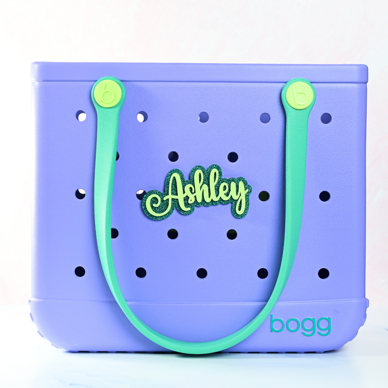 Personalized boggy button Custom Tote Bag Charm attached to a bogg bag with green boggy button on emerald green glitter