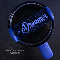Blue tumbler accessory personalized with 'Dreamer' name on a dark blue glitter background