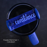 Blue tumbler accessory personalized with 'constance' name on a purple shimmer background