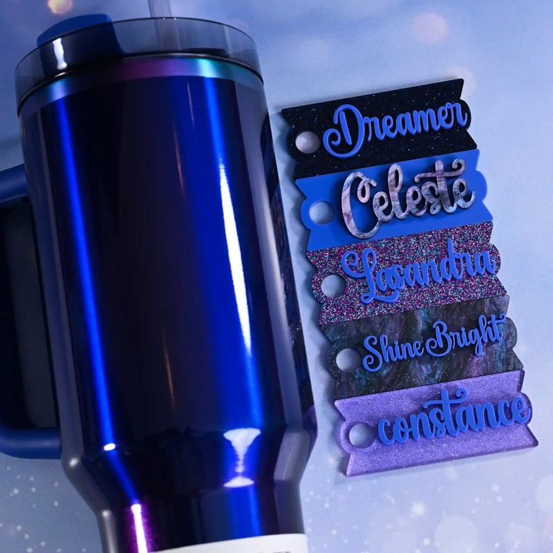 Blue metallic mug with decorative name tags on a light blue background