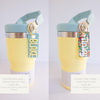 A collection of personalized tumbler charms in various colors and with different names printed on them, attached to a keychain ring.
